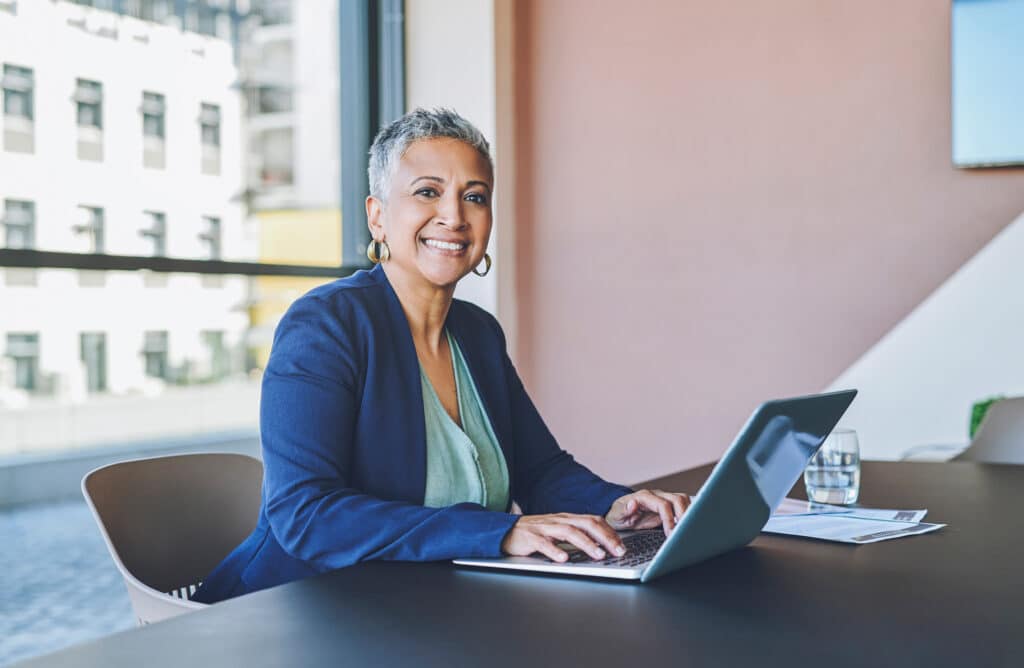 senior business woman typing on laptop, replying to emails and working on a proposal in an office at work. portrait of a mature female boss, manager and ceo browsing the internet and planning online