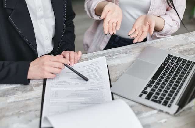 hands of two people with documents