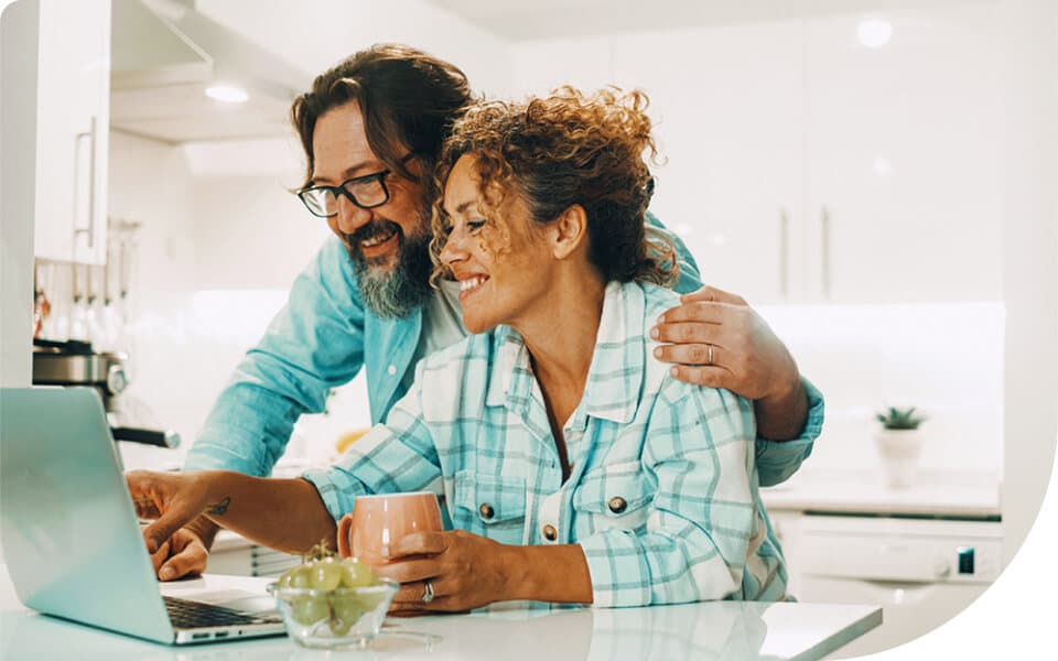 Two couples smiling while they surf the web