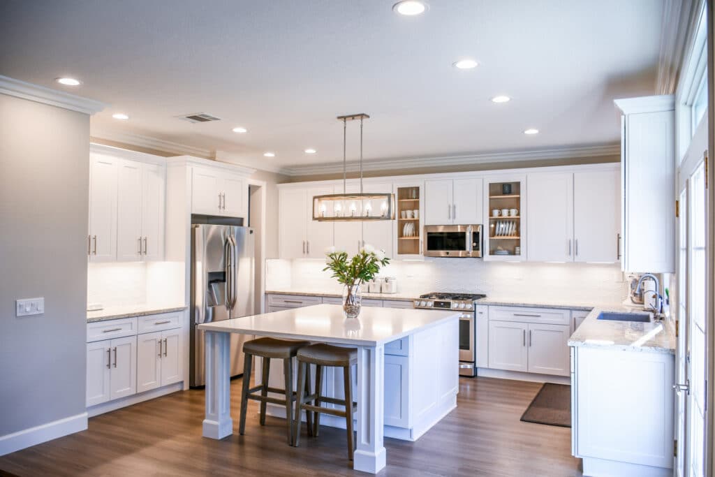 modern kitchen with light cabinets and overhead lighting