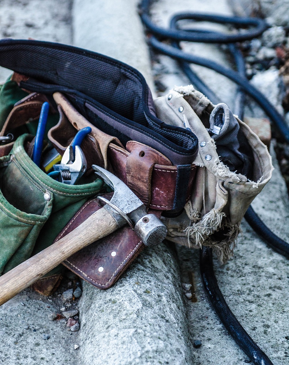 tools in a toolbelt laying on ground